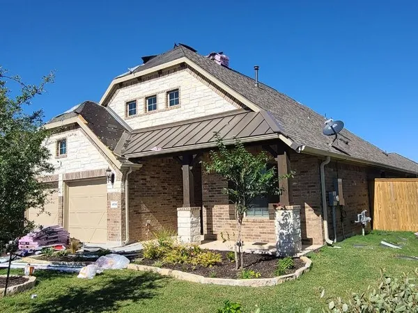 Finished roof on a stone and brick home
