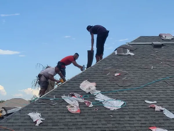 Crew installing shingles
