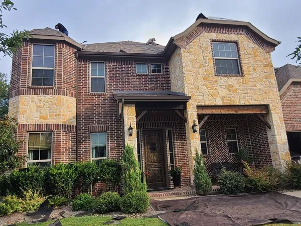 Two-story brick and stone home re-roof